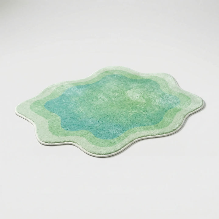 Plush gradient area rug with stylish wave pattern, a soft modern home decor accent for living room or bedroom.