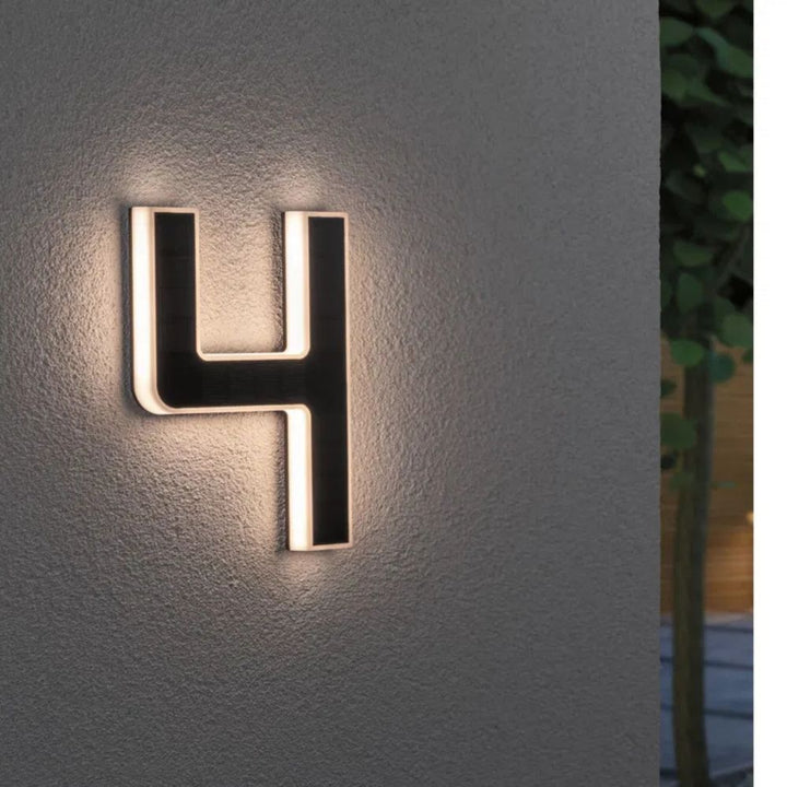 Outdoor LED house number with automatic solar charging for convenience.