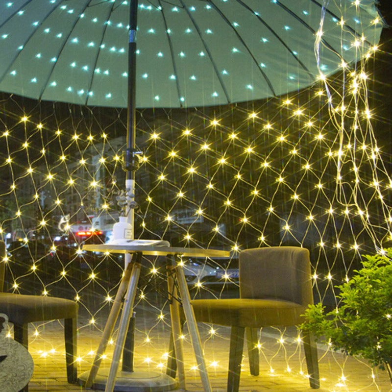 Close-up of solar panel charging LED mesh lights, ideal for sustainable garden lighting
