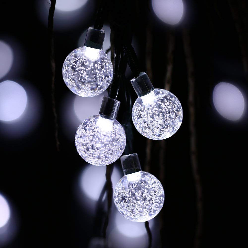 Patio decorated with warm glow of solar powered LED string lights, creating cozy atmosphere