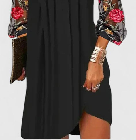Chic black mini dress for women, featuring a sophisticated v-neck & long sleeves, ideal for evening events.