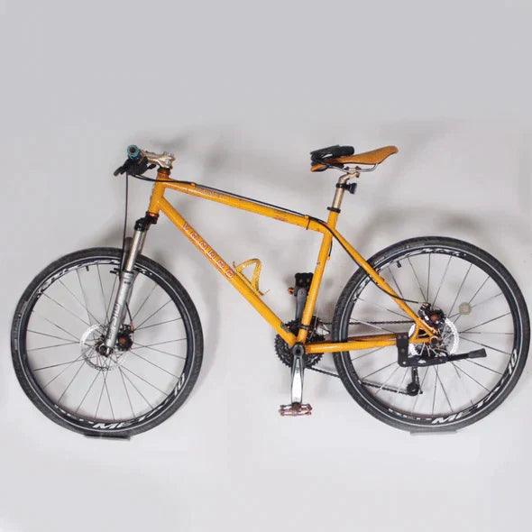 Sleek wall-mounted bike hanger, durable carbon steel, great for home decor & space-saving bicycle storage.