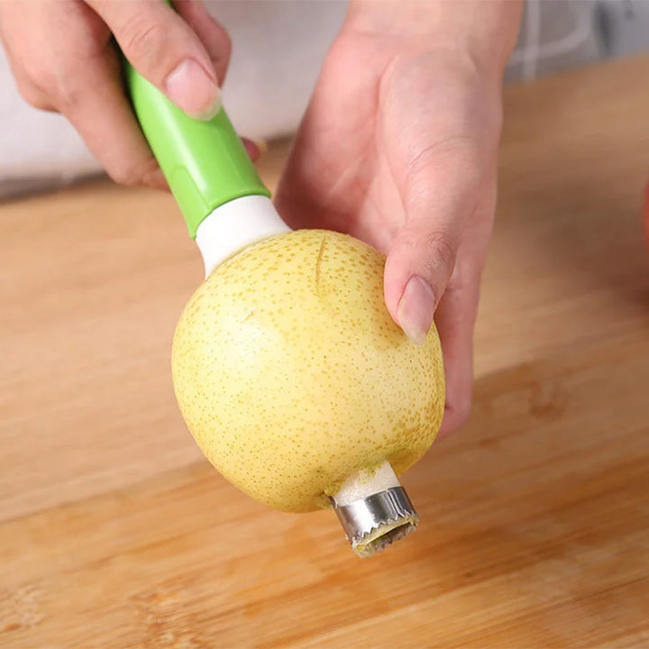 Hand holding a kitchen fruit corer, demonstrating its use for apples.
