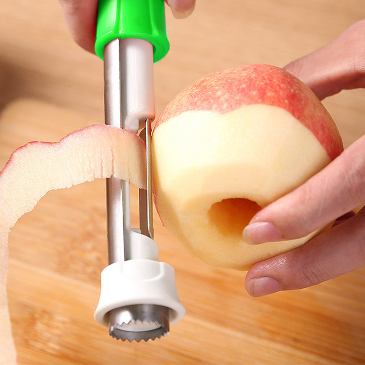 Kitchen gadget: fruit corer and peeler laying on a wooden cutting board.