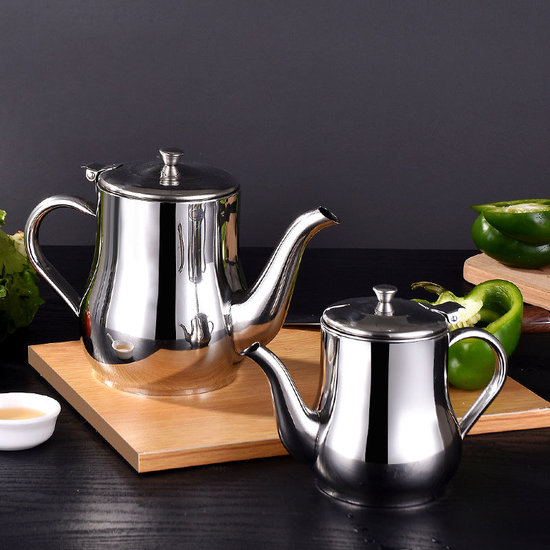Stainless steel oil dispenser, 1.2L, with lid, ergonomic handle, and fine mesh strainer for kitchen use.