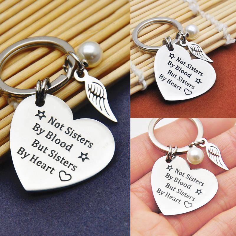 Stainless steel sisterhood keychain with 'Sisterhood' engraved, ideal friendship gift.
