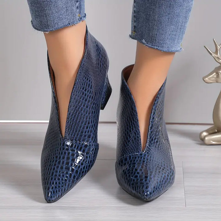 Stylish women's ankle boots with reptile texture, perfect for fall fashion and versatile wear.