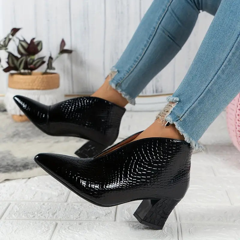 Women's stylish ankle boots with a sophisticated reptile pattern, ideal for dressy or casual looks.