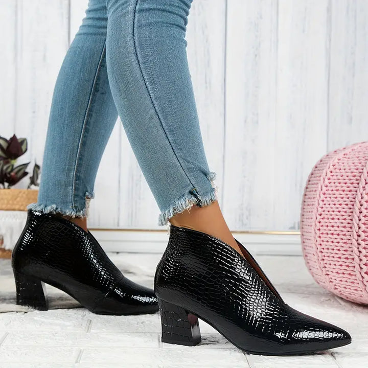 Full view of women's reptile-textured ankle boots, a comfortable and fashionable addition to winter attire.