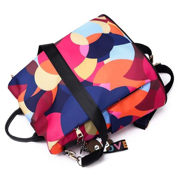 Adjustable straps & comfortable back panel of a women's anti-theft water-resistant backpack. Ergonomic design.