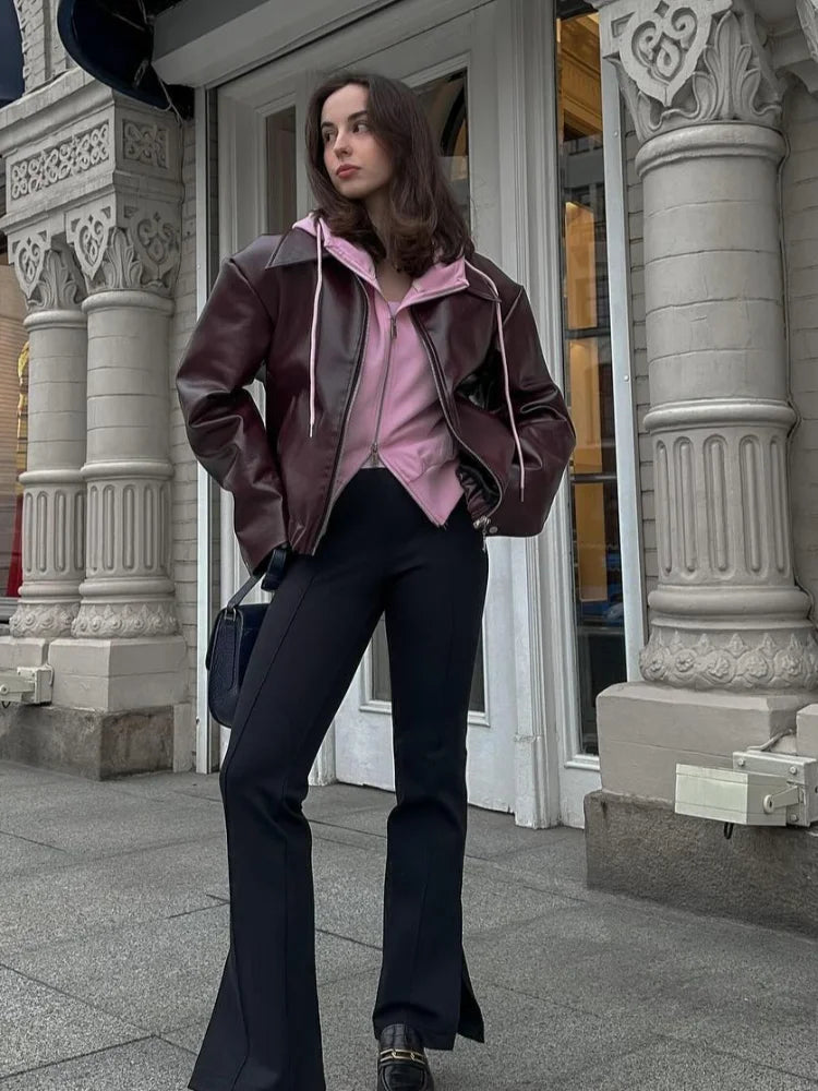 Stylish women's brown leather short jacket featuring a notched collar and zipper. Perfect for fall fashion outerwear.