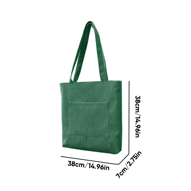 Full shot of a model carrying a women's corduroy casual tote bag, demonstrating its comfortable fit and style.