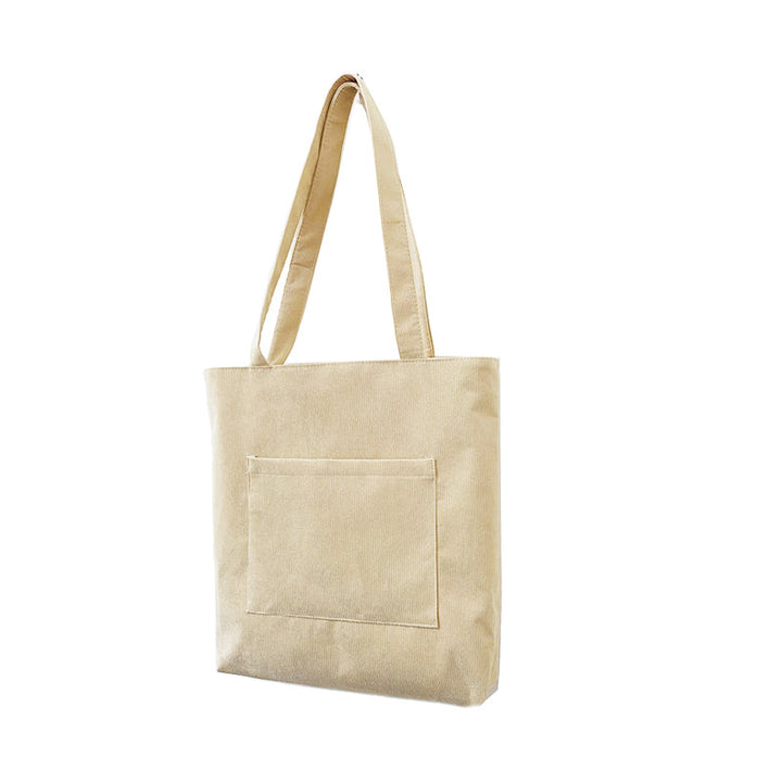 Interior view of the women's corduroy tote bag, revealing a well-organized space with additional pockets.
