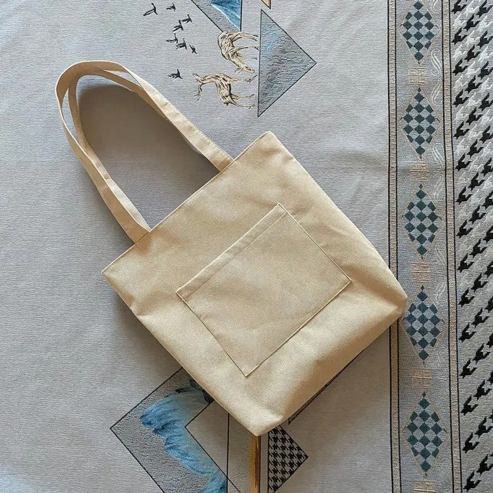 High-angle view of a women's corduroy tote bag, displaying its relaxed shape and capacity for various items.