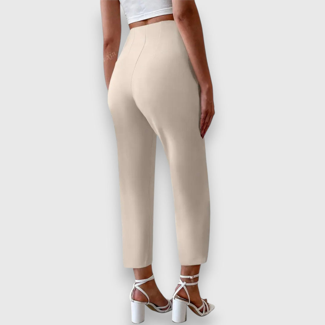 Close-up of elegant women's high-waisted tailored dress pants, showcasing quality fabric and straight leg design.