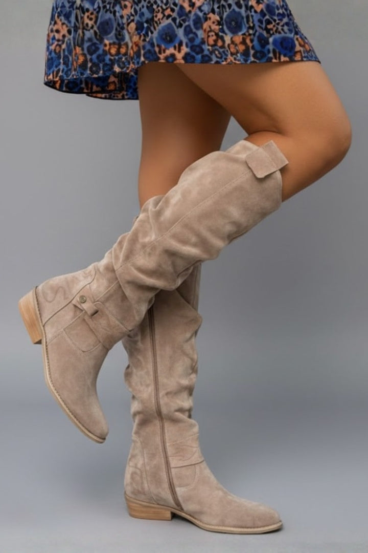 Chic beige women's knee-high boots with comfortable flat heel, ideal for fall & winter outfits.