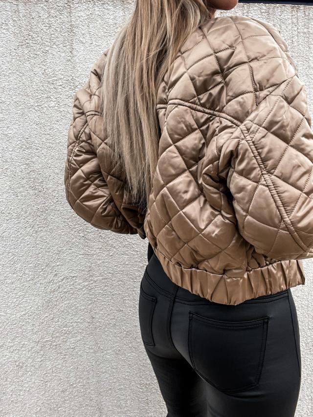 Classic women's bomber jacket, padded with functional pockets & zip closure. Stylish casual outerwear.