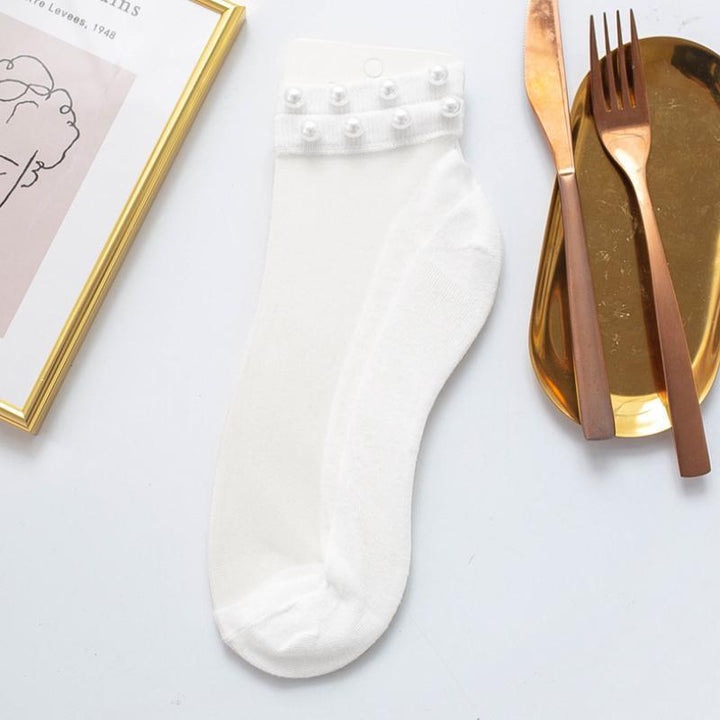 Women's pearl fishnet ankle socks, offering a blend of classic elegance and modern style.