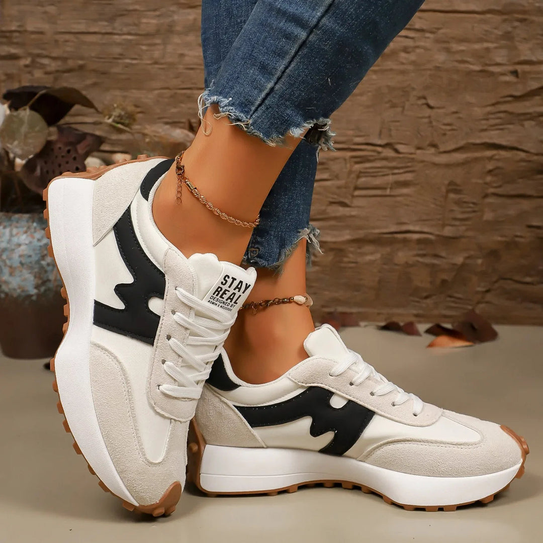 Fashionable female platform sneakers, striped detail, great for trendy casual outfits.