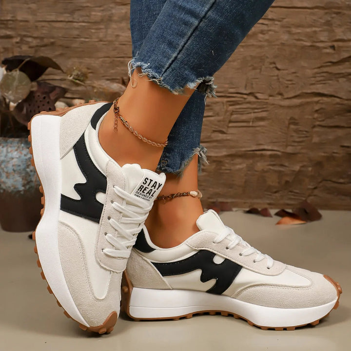 Fashionable female platform sneakers, striped detail, great for trendy casual outfits.