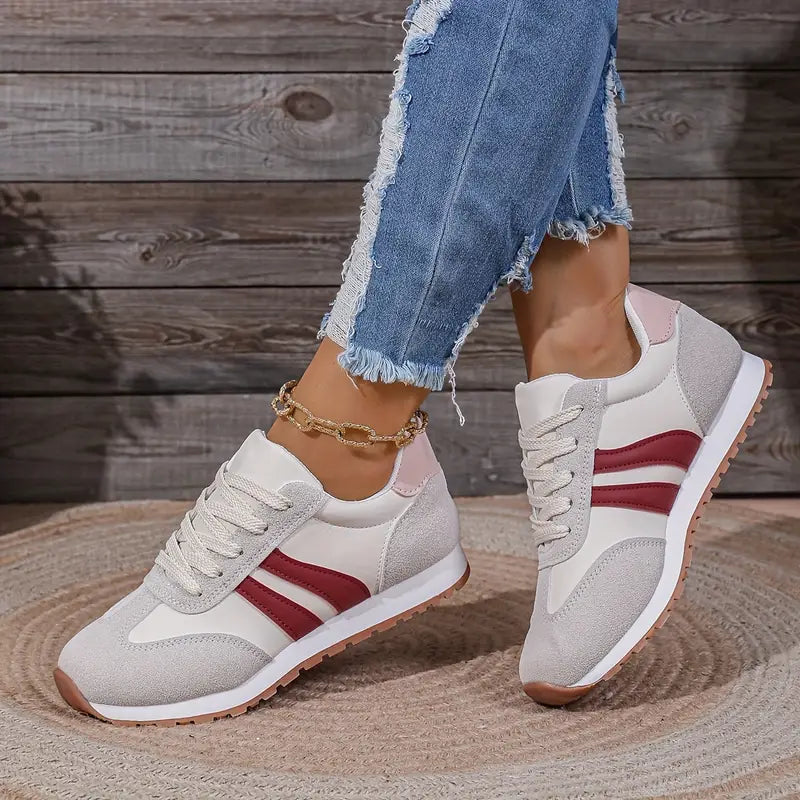 Comfortable women's fashion sneakers with a retro lace-up design. Stylish casual low-top shoes for everyday wear.