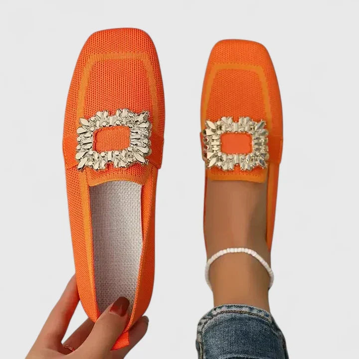 Elegant slip-on women's mules with a modern square toe and glittering rhinestone buckle detail.