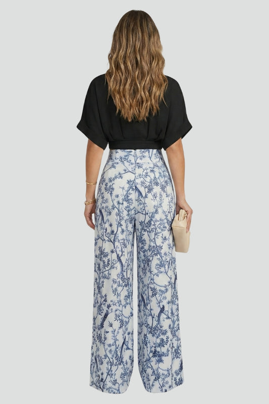 Chic women's resort wear outfit: V-neck top paired with flowy wide-leg trousers. A stylish and comfortable set.