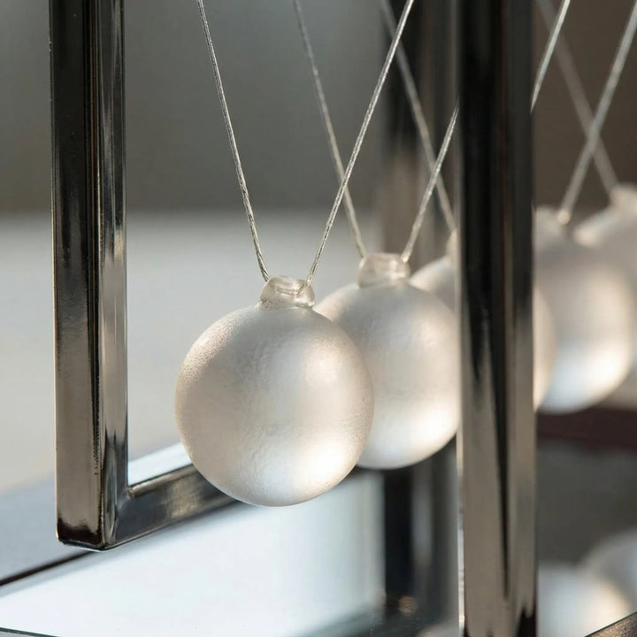 Modern kinetic desk decor, a soothing motion art piece for tabletop display. Ideal unique gift.