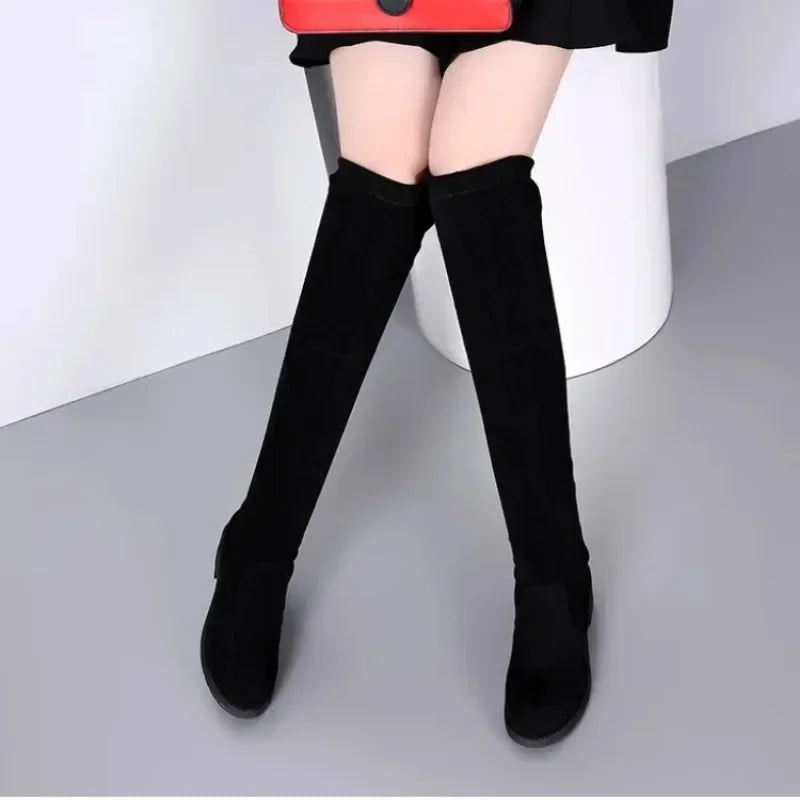 Side profile of women's black thigh-high fashion boots with a comfortable block heel