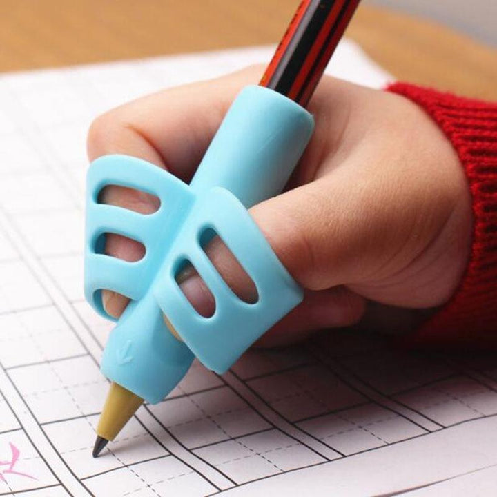 Three colorful silicone ergonomic pencil grips for kids, aiding comfortable writing and proper hand positioning.