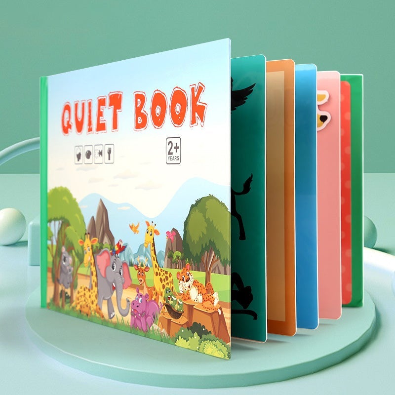 Child's hands engaging with a page of a busy book, practicing buttoning and hand-eye coordination.