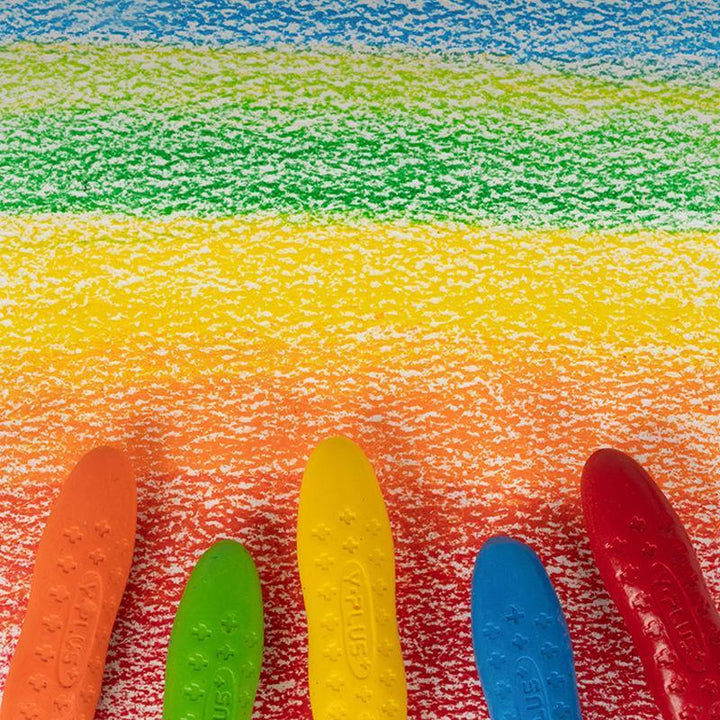 Toddler holding easy-grip peanut crayon, washable and non-toxic for safe art activities