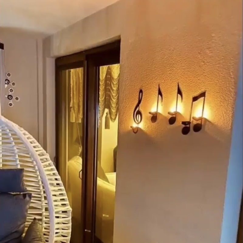 Intricate music note metal sconce with candle dish, adds melodic touch to any room