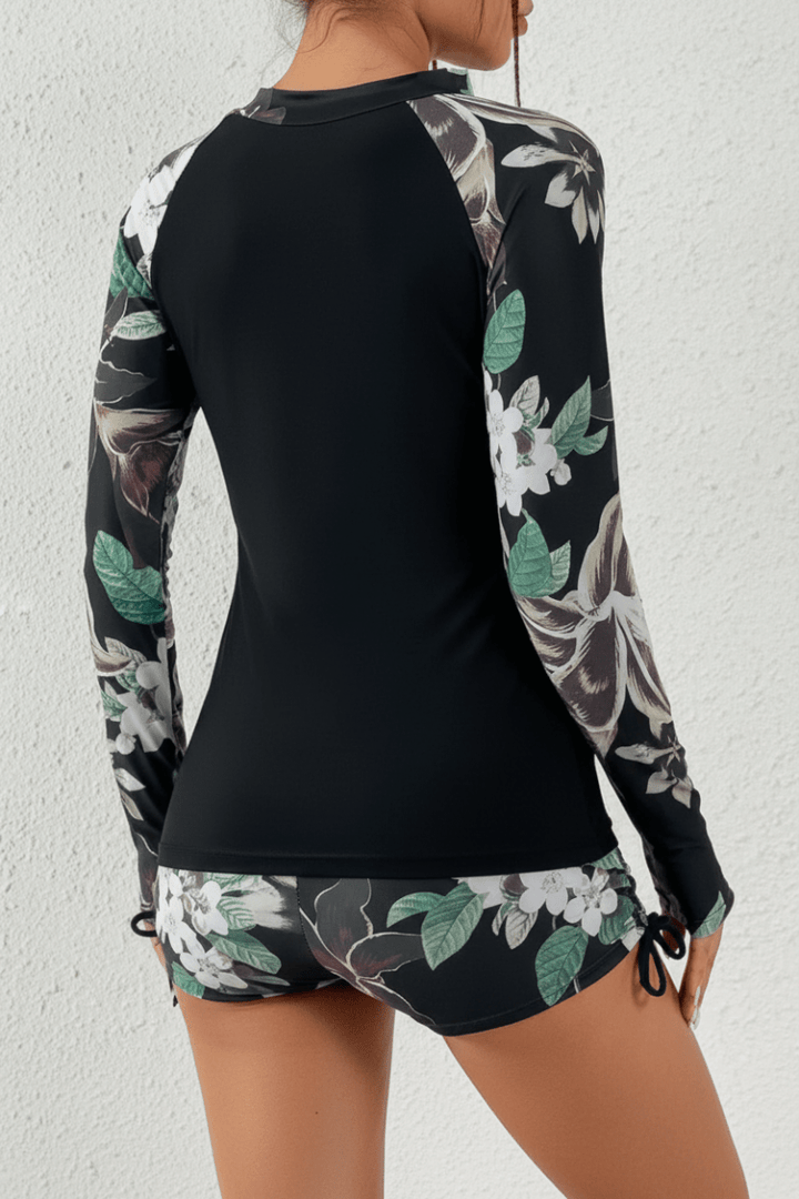 Women's active tropical rashguard swimsuit, providing sun protection. Two-piece long sleeve beachwear.