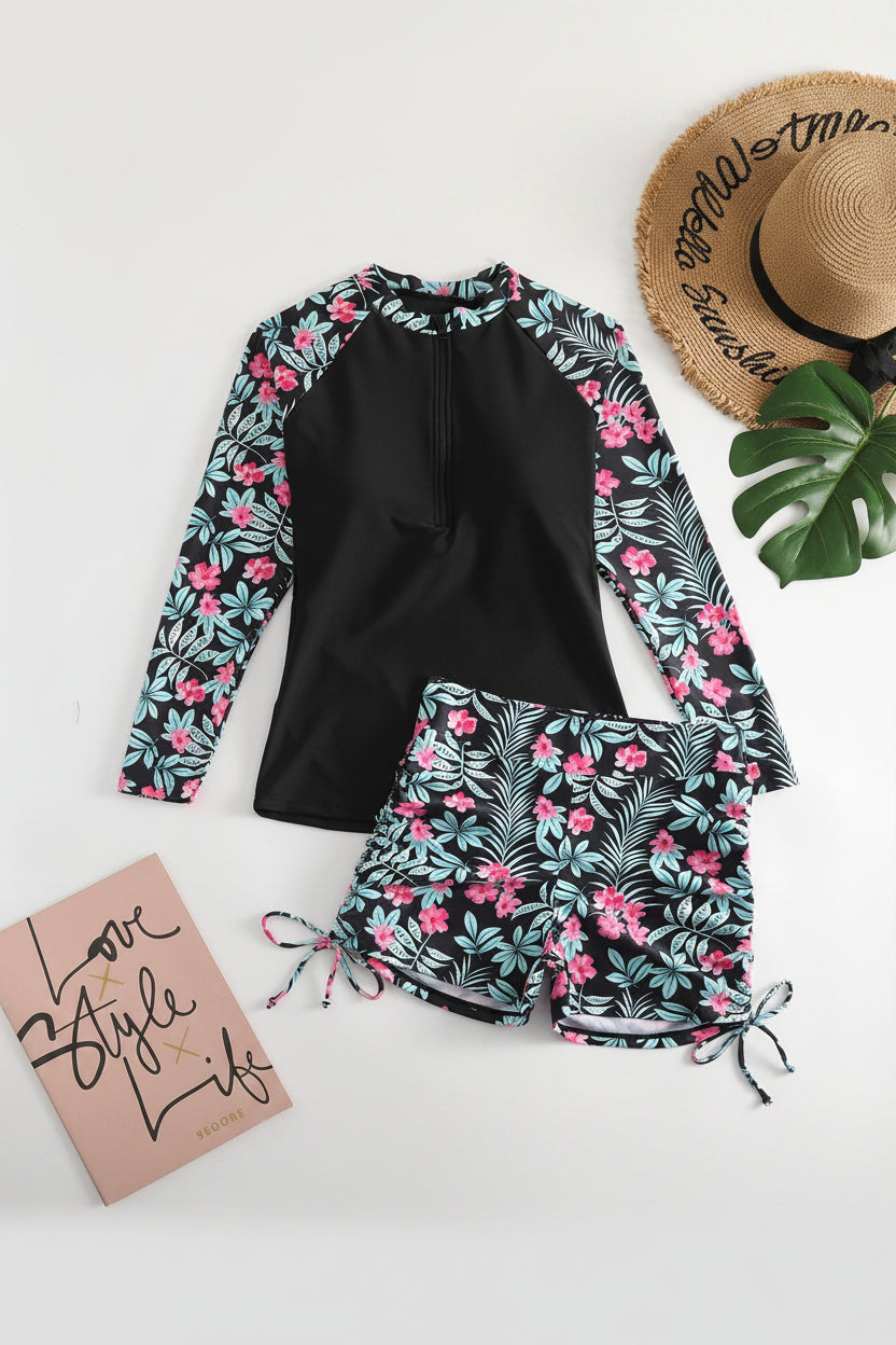 Women's sporty two-piece rashguard swimsuit with long sleeves & tropical design. Perfect for active wear.