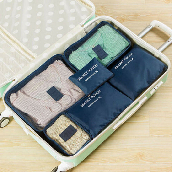 Suitcase interior with packed waterproof travel cubes. Neatly organized vacation essentials & gear.