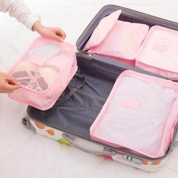 Compressible packing cubes maximizing luggage space. Essential travel organizer for extended trips.