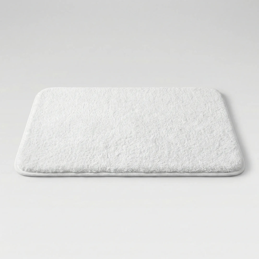 Plush absorbent bathroom mat, non-slip & washable, featuring a modern wave pattern.