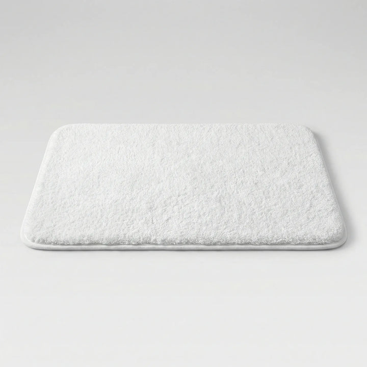 Plush absorbent bathroom mat, non-slip & washable, featuring a modern wave pattern.