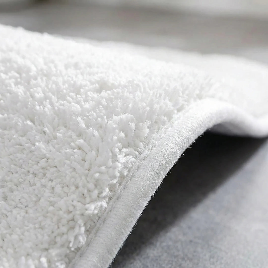 Soft Flowique wave bath mat, highly absorbent & ultra-plush, perfect for home decor.