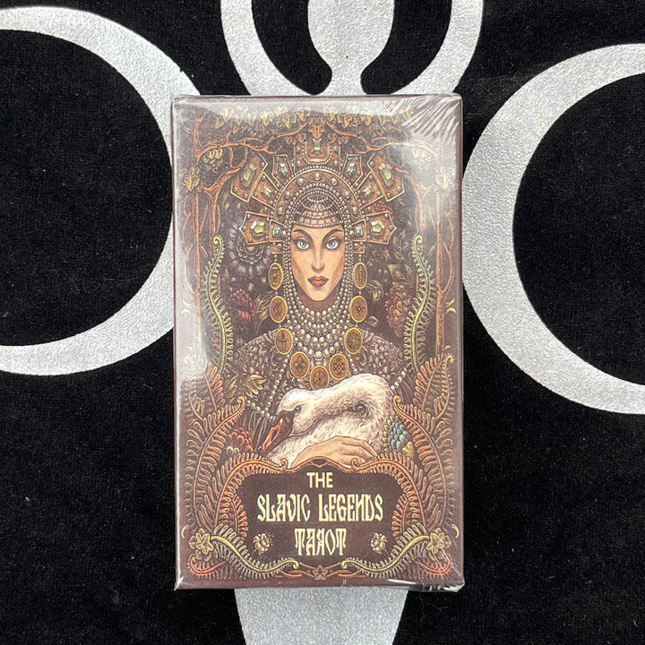 A pair of hands examining the unique illustrated tarot cards, highlighting connection and introspection