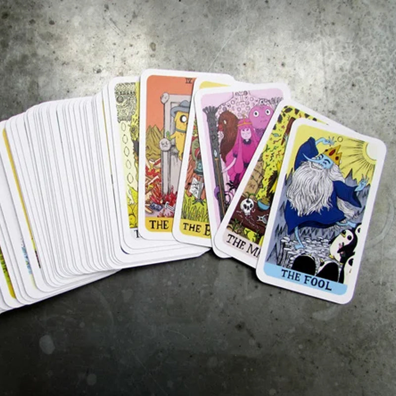 The unique illustrated tarot deck accompanied by a small crystal, enhancing its spiritual ambiance