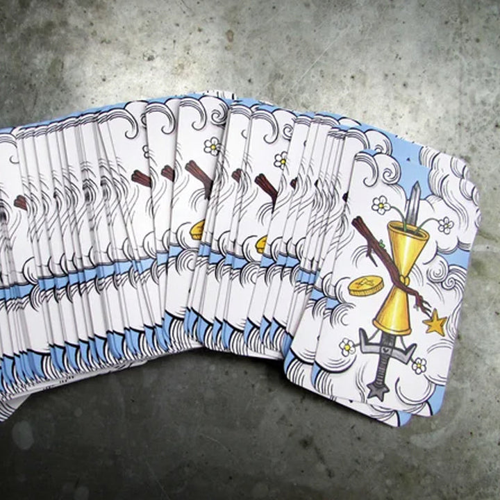 Tarot deck box beside several drawn cards, illustrating a typical divination setup for spiritual guidance