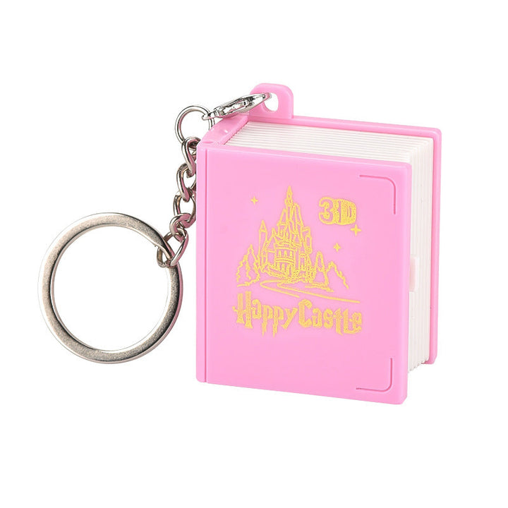 Kids hands playing with the pop-up feature of the 3D Book Keychain, a engaging fidget toy