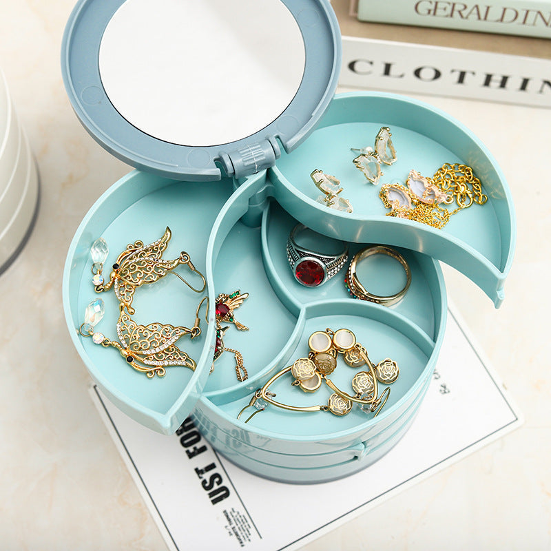 Close-up of a rotatable 4-layer white jewelry storage box, showcasing a layer filled with earrings