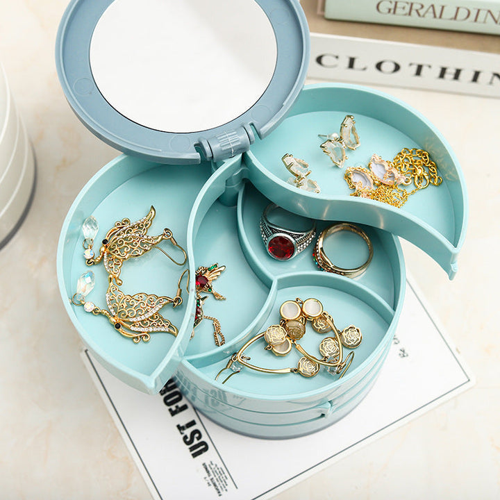 Close-up of a rotatable 4-layer white jewelry storage box, showcasing a layer filled with earrings