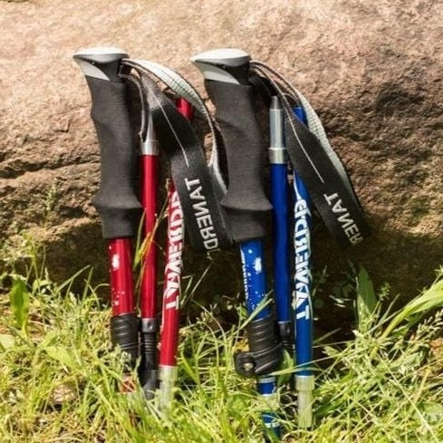 Close-up of lightweight aluminum folding trekking pole with ergonomic grip & quick-lock adjustment. Outdoor gear.