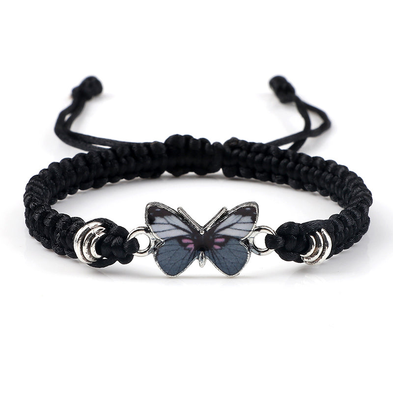 Detail shot of the secure adjustable knot on a woven butterfly charm bracelet.