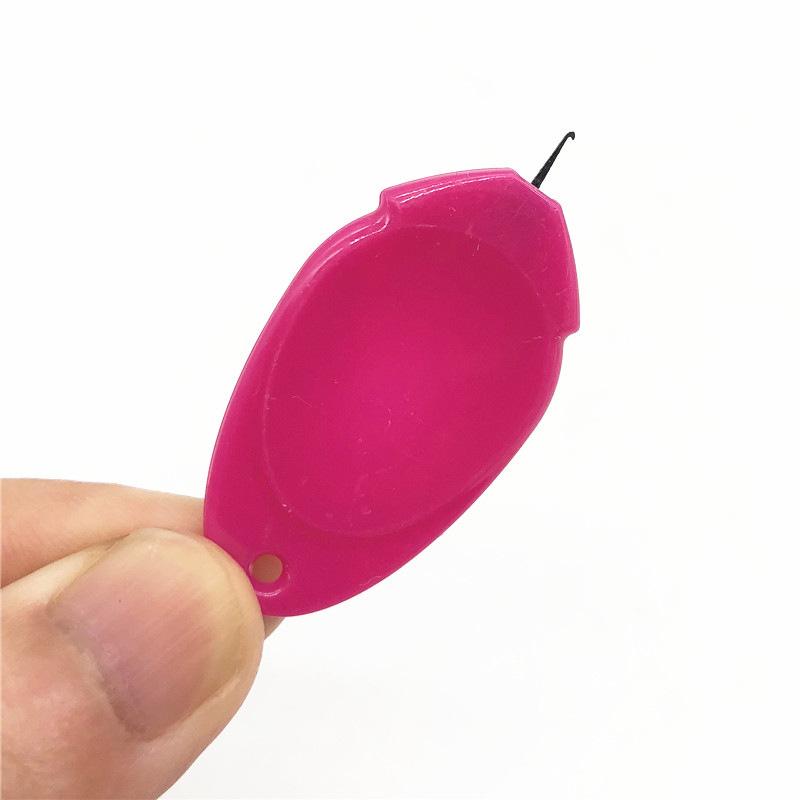 Compact household automatic needle threader gadget for easy sewing and crafting.