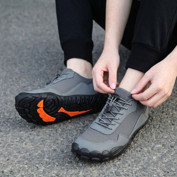 Side profile of orthopedic hiking shoes with flexible sole, wide toe box, and natural fit for trails.